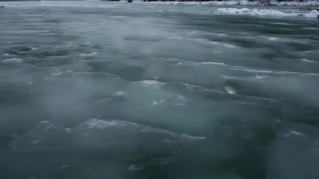 Frozen Water's Embrace: An abstract shot of the ice water. This photo invites viewers to contemplate the cold and mystery of winter. 