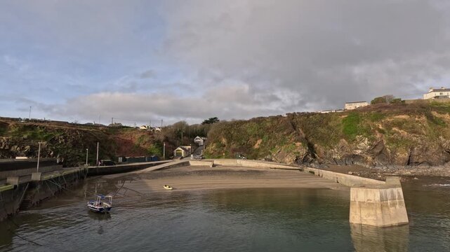 The pier at Tramore Ireland protected by concrete breakwater, golden