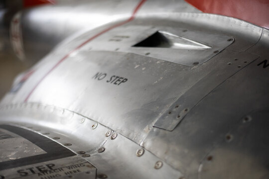 Aircraft metal skin showing warning message and rivets