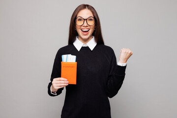 Traveler employee business woman lawyer in black clothes hold passport ticket isolated on plain...
