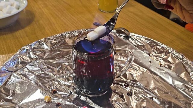 Flaming Schnapps with Melting Sugar in Traditional Alpine Ritual, Ebensee, Upper-Austria