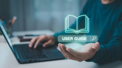 Person typing on laptop with digital user guide and search icon glowing over open hand