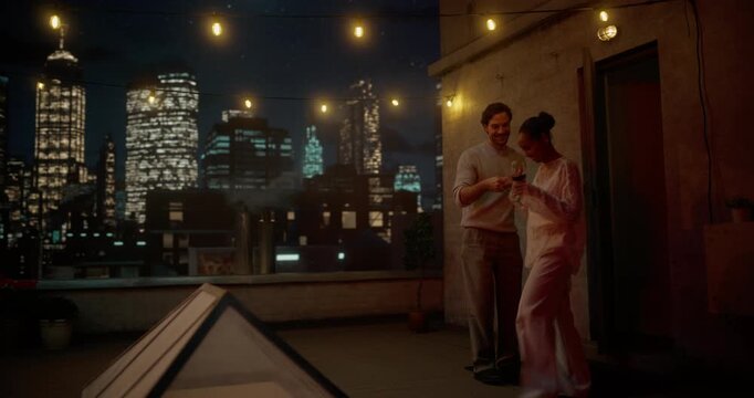Young Couple Go on Roof with Romatic Dinner Terrace. Chat, Drink Wine at Cozy Table, Laughing, Toasting and Sharing Stories. Evening Into a Romantic Connection, Future Dreams and Family Plans Together