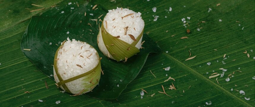 Indonesian Lepet: a snack of sticky rice and grated coconut, seasoned and wrapped in coconut leaves, cylindrical and boiled