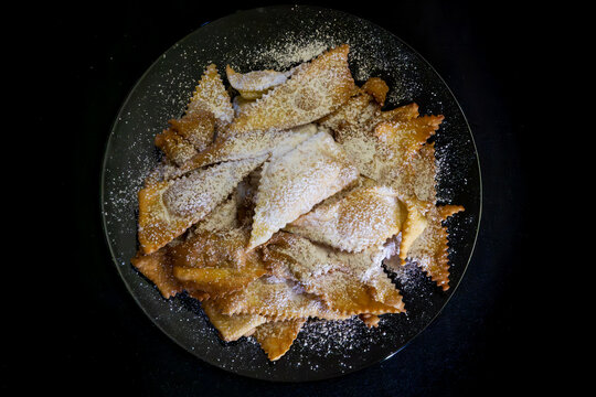 Italian food carnival sweets dessert chiacchiere frappe bugie cenci crostoli galani angel wings fried pastry dough powdered sugar crispy crunchy delicious traditional recipe homemade snack calories