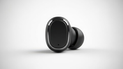 Black wireless earbud on a white surface with sleek design and technology