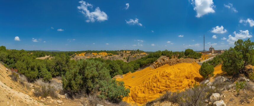 Cyprus Memi pyrite mine restoration area featuring yellow tailings and reforestation