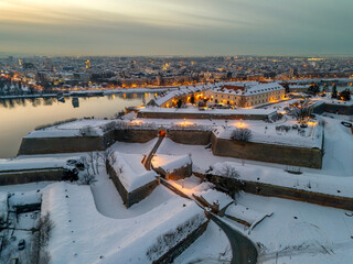 Aerial Sunset View of Petrovaradin Fortress Covered in Snow over the Danube River, Novi Sad, Serbia