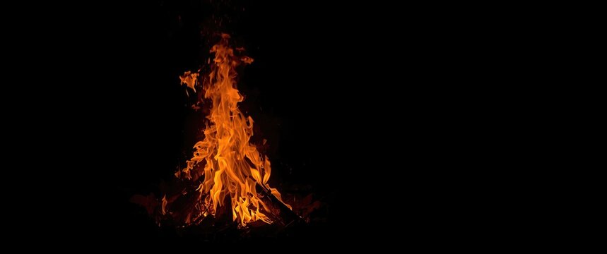 Detailed image of a bonfire with burning fire wood and a glowing fireplace look on a dark backdrop