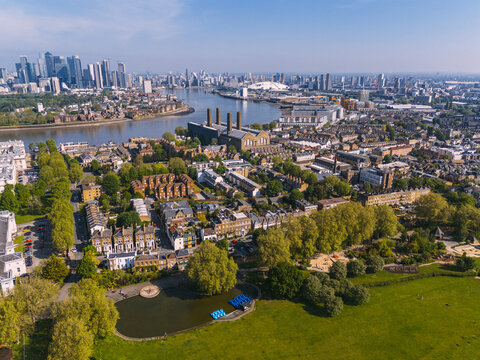 Aerial view of Battersea Power Station standing proudly amidst the Thames, a stark contrast of industrial heritage against the modern skyline, London, England, United Kingdom.