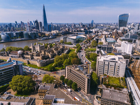 Aerial view of the Tower of London and the Shard against the Thames, with the Walkie Talkie building gleaming in the distance, London, United Kingdom.
