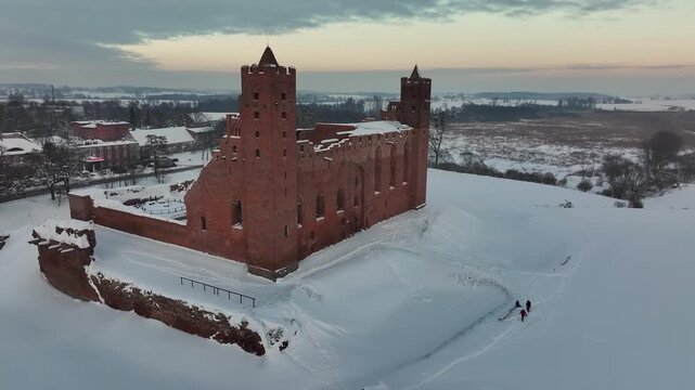 Aerial winter recreation Teutonic Castle Radzyn Poland circle 4K. Brick Gothic monastery castle built 1234 AD Teutonic Knights 10th century. Historical buildings, tourist attractions, parks, farms.
