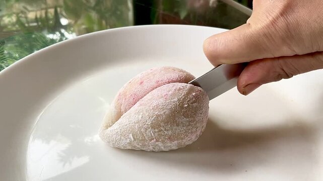 Japanese dessert mochi with strawberry filling. Sliced mochi with strawberry filling close-up.