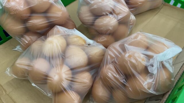 Fresh eggs in plastic bags at market