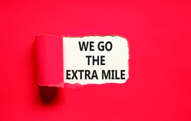 Support, help we go the extra mile symbol. Concept words We go the extra mile on beautiful white paper. Beautiful red paper background. Business we go the extra mile concept. Copy space.