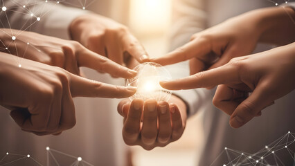 Multiple hands touching a bright light symbolizing teamwork and innovation.