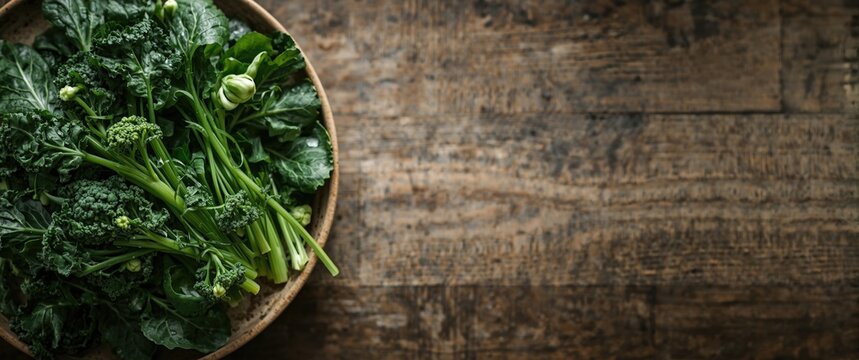 Fresh rapini broccoli rabe arranged on a plate from above with space for text