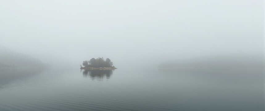 In Agios Athanasios, enjoy a picturesque scene of a fog-covered lake in Kastoria