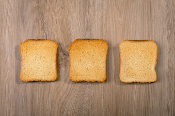 Rusks bread pieces on wooden table surface