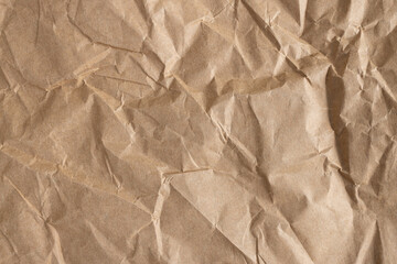 Close-up macro shot of a wrinkled brown kraft paper background,Top view of wrinkled and crumpled...