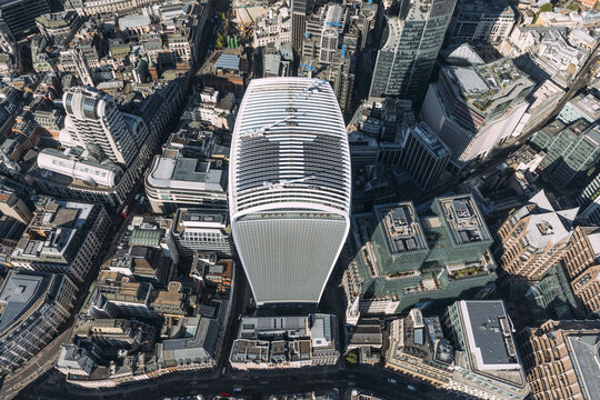 Aerial view of the Walkie Talkie building stands tall, a modern monolith amidst the historic cityscape, casting long shadows across the intricate urban tapestry, London, United Kingdom.