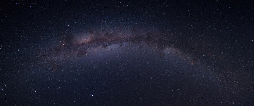 Wide-angle view of the Milky Way galaxy showing stars and space dust in the universe, long exposure photograph, high resolution with grain