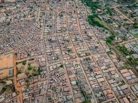 Aerial view of densely packed buildings, streets, and vibrant green spaces create a textured tapestry of urban life, Kaduna, Kaduna, Nigeria.