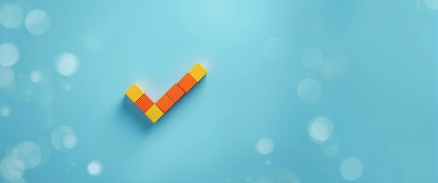 Tick symbol created from wooden blocks on blue background