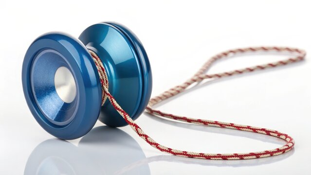 A close-up shot of a classic blue yo-yo with its string lying beside it