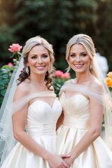 two beautiful young women in white wedding dress, happy together, lesbian wedding concept 