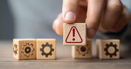 The warning block held above gear cubes symbolizing risk and system failure