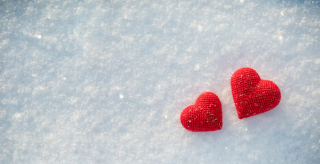 Pair red hearts on snow background in sunny winter for Valentine day banner or card.