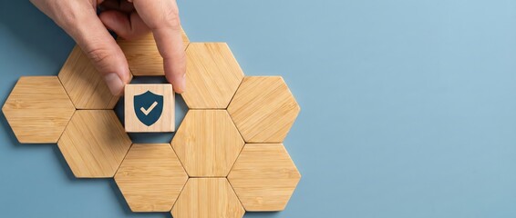 Hand placing shield checkmark cube on honeycomb structure, concept of security and protection