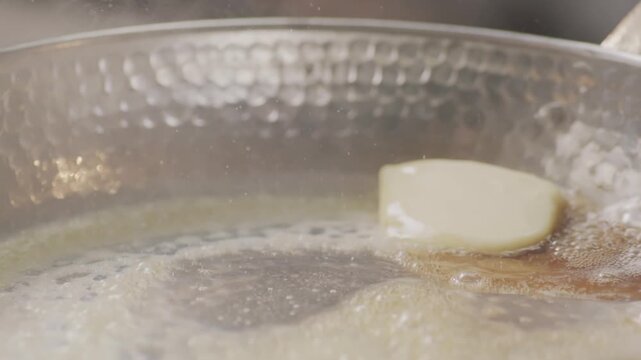 Cube of Butter Melting Sizzling Browning in Non Stick Pan Skillet in Slow Motion, Preparation for Cooking - 100 FPS
