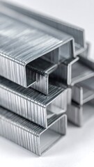 Obraz premium Stack of metallic staples. Stacked closely on a bright, solid surface