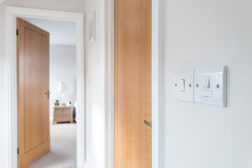 Shallow focus of a pair of upstairs electrical switches seen within the upper floor of a recently completed loft conversion to a bungalow.