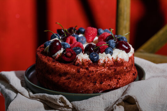 Moist red velvet cake with creamy frosting, a classic American dessert for celebrations.