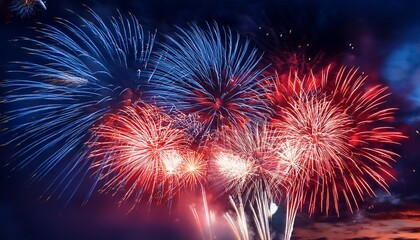 vibrant red and blue fireworks exploding in night sky celebration