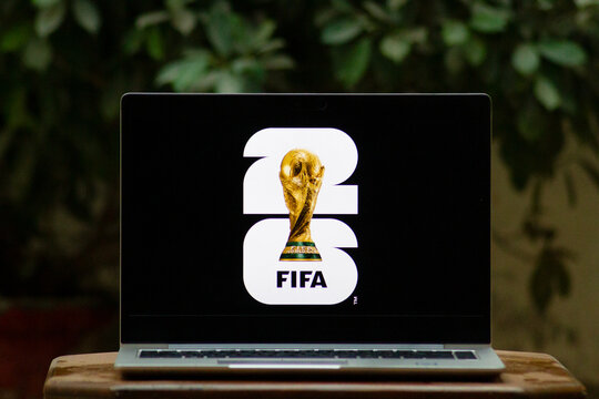 Karachi, Pakistan, 10 January 2026, FIFA World Cup 2026 Logo on a Laptop with an outdoor background. Soccer or football Tournament social media post with a laptop and an outdoor green background. 