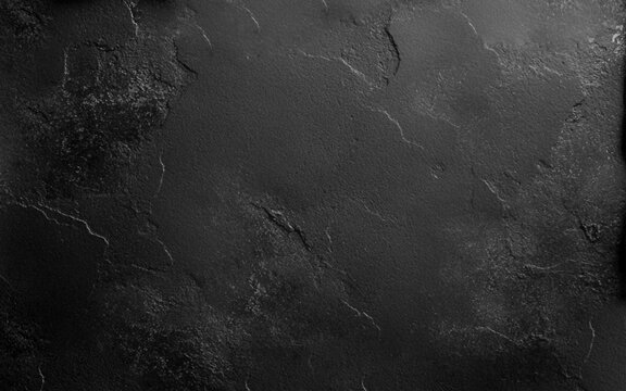 Dark stone surface offering a sleek, minimalist look. Dark premium background for website banners and posters.  Empty rough cement wall or floor background. Top view, close up, copy space
