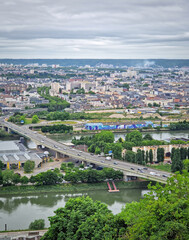 Rouen, France - May 29, 2025: Elevated view of the french city of  Rouen, from the hill Sainte-Catherine, under a cloudy sky, with Seine river in the foreground