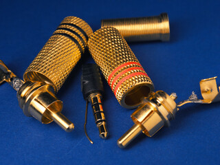 Close up of gold plated plugs on a blue background, gold recovery, resource saving