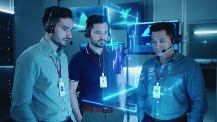 Three male tech support specialists wearing headsets monitoring holographic data displays in control room. Team collaborating on network systems with animated blue interface graphics - Powered by Adobe
