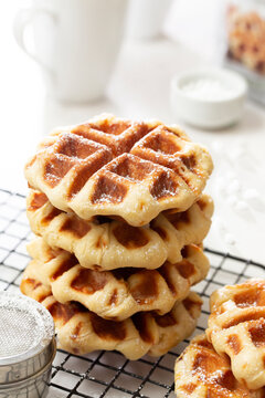 A Stack of Freshly Made Belgian Waffles on Cooling Rack