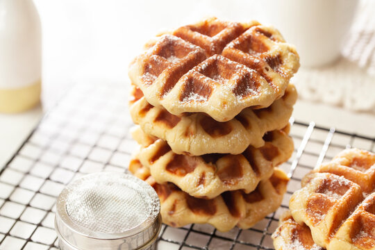 A Stack of Freshly Made Belgian Waffles on Cooling Rack