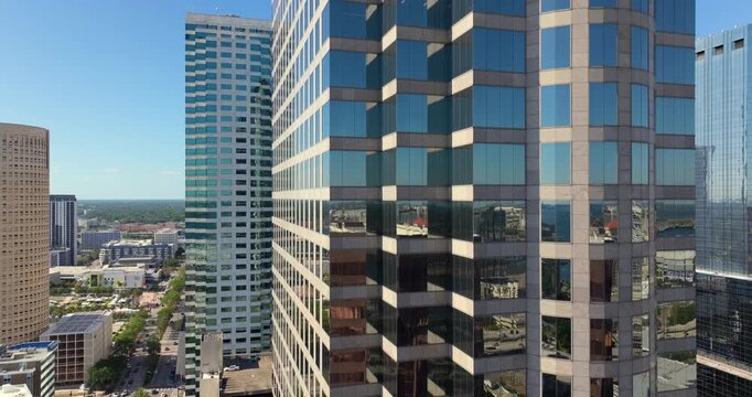 Glass bank skyscraper in Tampa city with reflections of financial downtown district in Florida, USA. American urban landscape on sunny day.