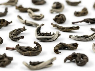 Close-up of Dried Green Tea Leaves on White Backdrop, Artistic Display