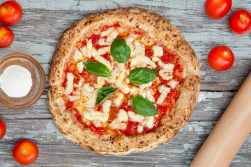 Pizza margherita in Italy just out of oven on wood table