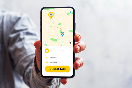 Man holding smartphone with taxi booking mobile app interface on screen. City map with route, pickup and destination points. Concept of ride hailing service, urban transportation and mobility app.