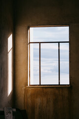 Fototapeta premium unlight and Shadow Play Through an Old Window on Concrete Wall